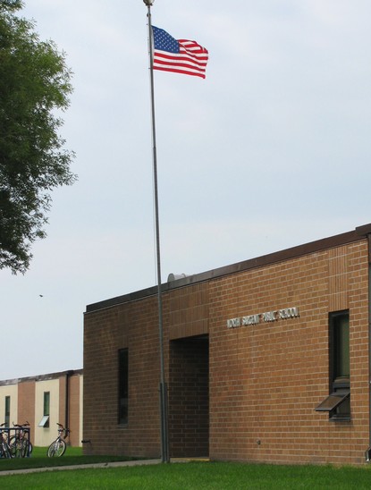 Red Brick School Building with U.S. Flag Flying